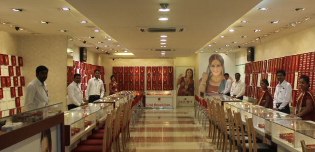 Image of the interiors of a jewellery shop named SHUBH Jewellers in India with sales assistant eager to help 