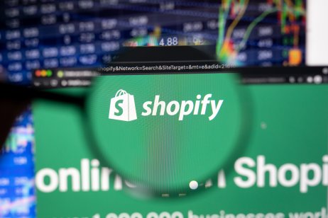 The Shopify website in front of a price graph