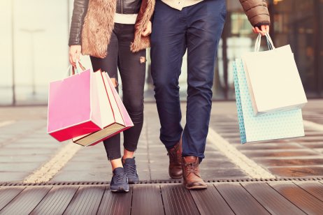 Man and woman walking with shopping bags