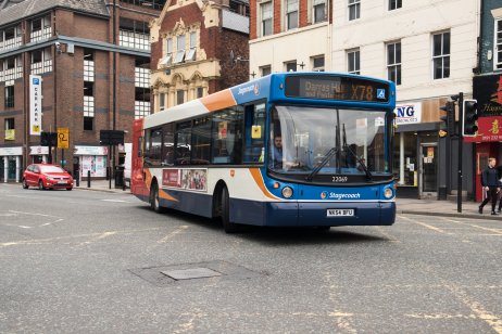 Bus driving through a town centre 