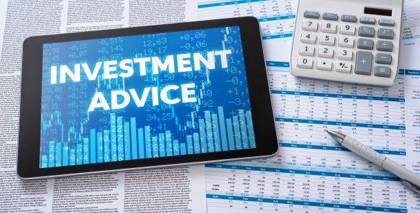the words investment advice written in block letters on a mobile screen in a blue background of stock market charts 