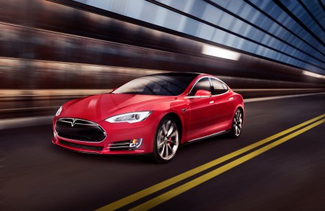 Red Tesla Model S luxury electric car speeding through a tunnel