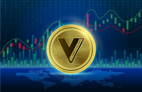 The VGX coin in front of a price graph