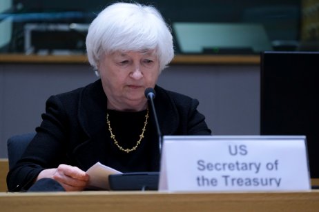 Janet Yellen, US Treasury Secretary, looks at her notes in front of a microphone 