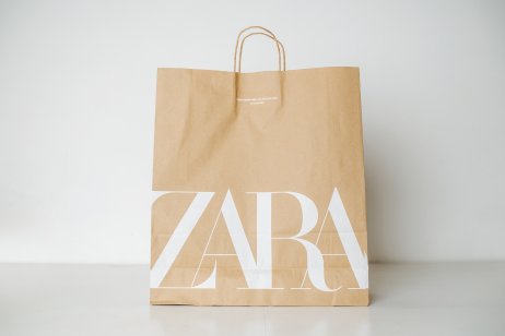 A brown paper bag with white Zara logo 