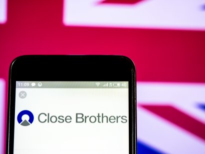 A picture of a Close Brothers Group plc company logo seen displayed on smart phone
