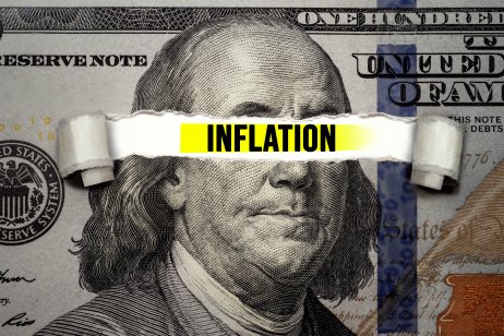 A $100 note with ‘inflation’ graphic across the eyes of Benjamin Franklin