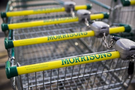 A row of Morrisons shopping trolleys in a store
