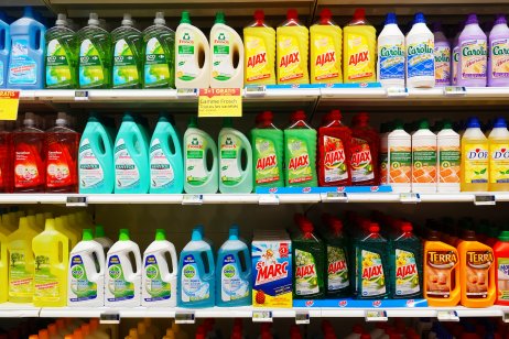Shelves stocked with brightly coloured assortment of cleaning products in a Carrefour hypermarket.
