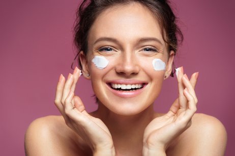 Woman applying moisturising cream on her face