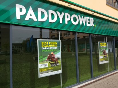 Photo of a Paddy Power retail franchise shopfront with white logo on green background