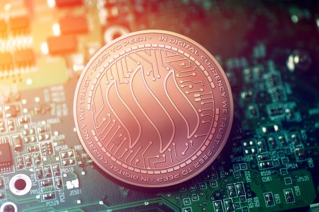 The abstract Steem logo depicted on a bronze coloured coin, against a circuit board background