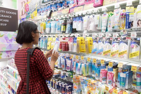 A young woman chooses cosmetics at a store in Osaka, Japan.