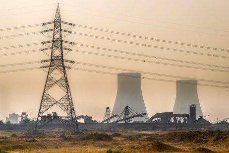  Coal-fired power station in Bushra near Allahabad, India, with high voltage pole during winter smog