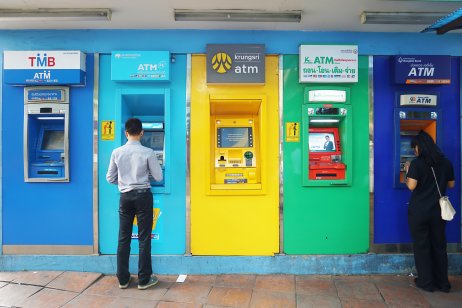 People withdraw cash from Thai ATMs