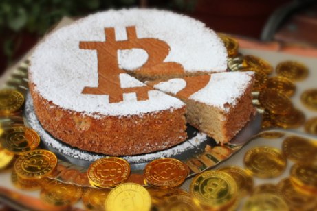 A birthday cake with the bitcoin symbol on top
