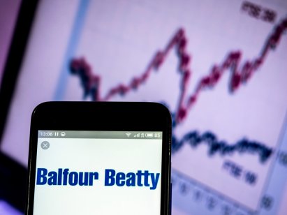 Balfour Beatty logo on a smartphone with a generic trading chart in background