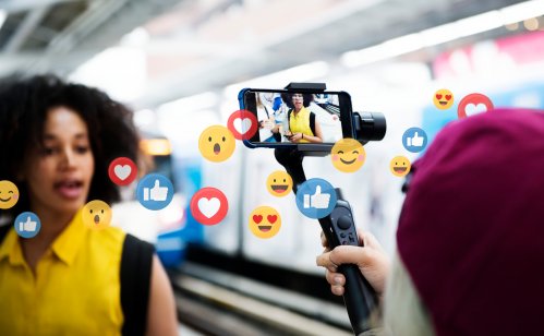 Vlogger streaming a live video live at a train platform