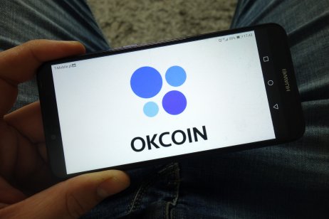 Okcoin logo on a smartphone 