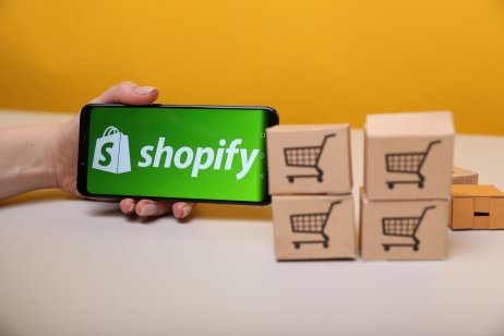 Shopify stock forecast: To buy, or not to buy SHOP post-split? Shopify on the phone display.