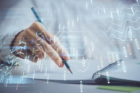 Financial forex graph displayed on hands taking notes background. Concept of research. Double exposure