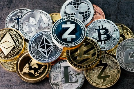Metal coins with cryptocurrency symbols