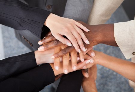 Businesspeople stacking hands over each other
