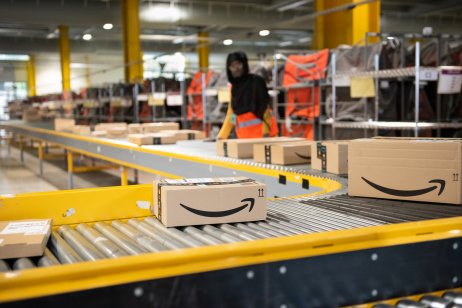 Inside an Amazon warehouse where a worker is overlooking a production line