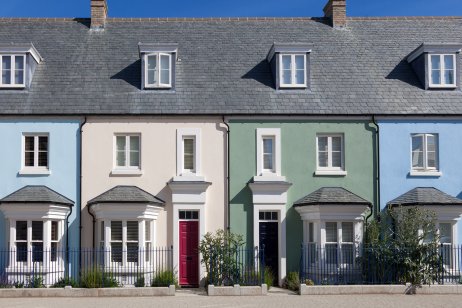 A terrace of houses painted in a variety of pastel shades