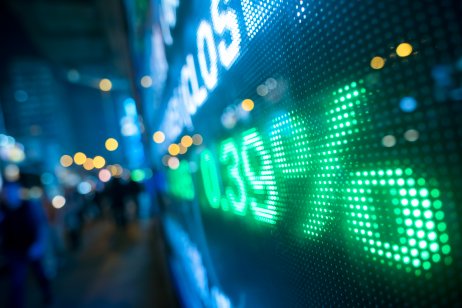 Display of stock market numbers with defocused street lights in the background 