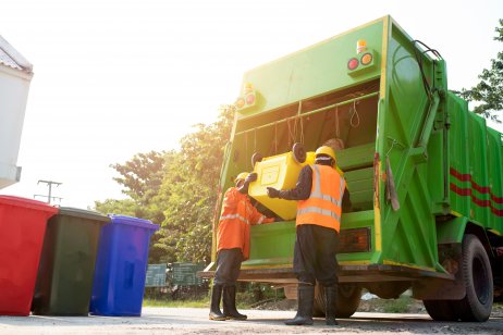 Workers loading garbage truck