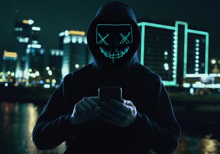 A hooded crypto scammer