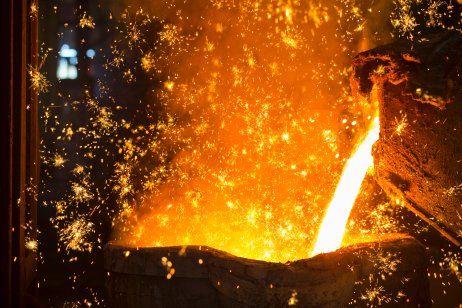 Shower of sparks as molten metal is poured in steel foundry