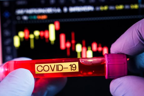 Covid-19 vial with stock chart background