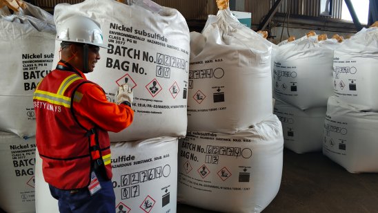 A worker showing bags of nickel ready for export at Vale's smelter in Sulawesi, Indonesia 