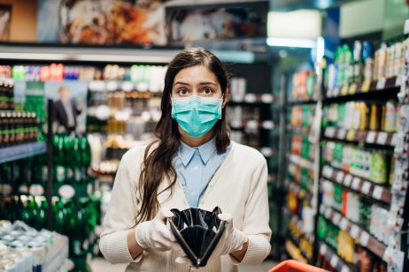 A woman shopping with a mask and empty purse