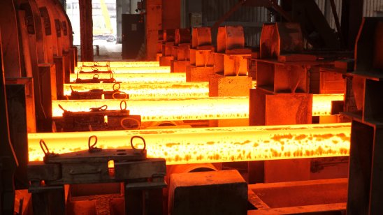 Metal glowing from heat at a steel mill.