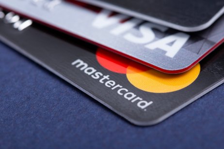 A photo of Visa (V) and MasterCard (MA) credit cards.