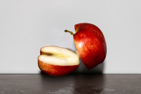 An apple divided into two halves.