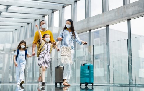 Family wearing masks at an airport