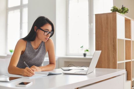 A woman studies using a laptop