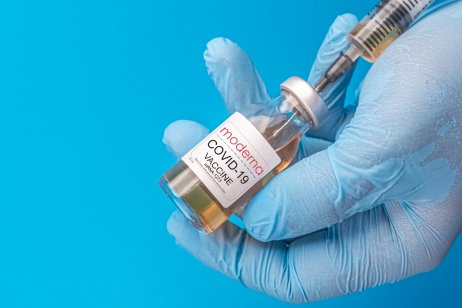 Vaccine in a bottle held in hands