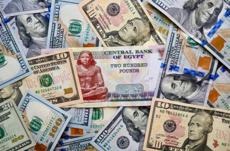 US dollar and Egyptian pound banknotes overlapped