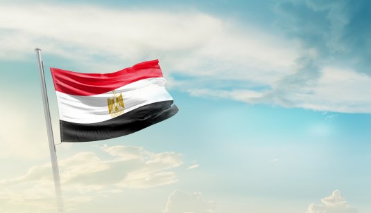 Egypt national flag waving in beautiful sky.