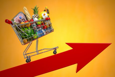 Grocery cart rolling on an upward red arrow, illustrating inflation