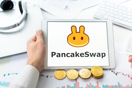 Pancakeswap logo.Cryptocurrency decentralized exchange DEX, tablet.Trading blockchain platform to swap,buy,sell crypto token,digital coin