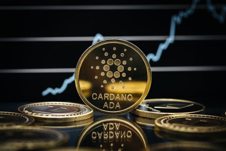 Cardano ADA coins, price chart going upwards on the background 