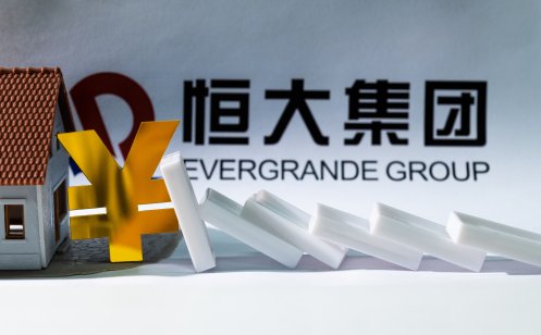 Evergrande Group logo with model house and falling dominos