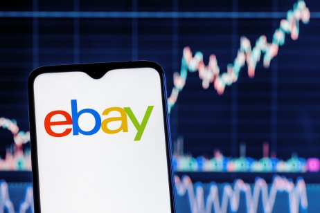 Kazan, Russia - Sep 25, 2021: eBay is an e-commerce corporation that offers online shopping, auction and marketplace services. Smartphone with eBay logo on the background of the stock chart.