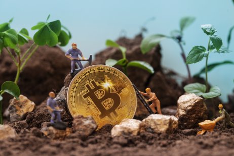 Miner figurines digging ground to uncover big Gold bitcoin